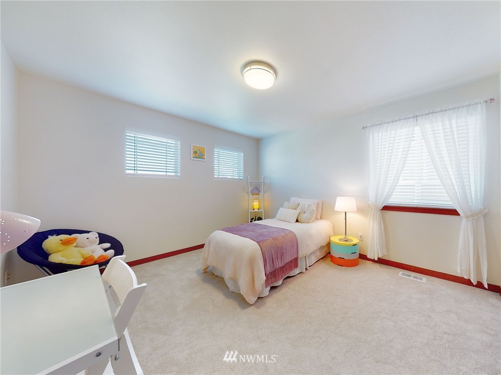 4002 216th Place Southeast Bothell, WA 98021 - Photo 24 of 28 a spacious bedroom with a bed and a window