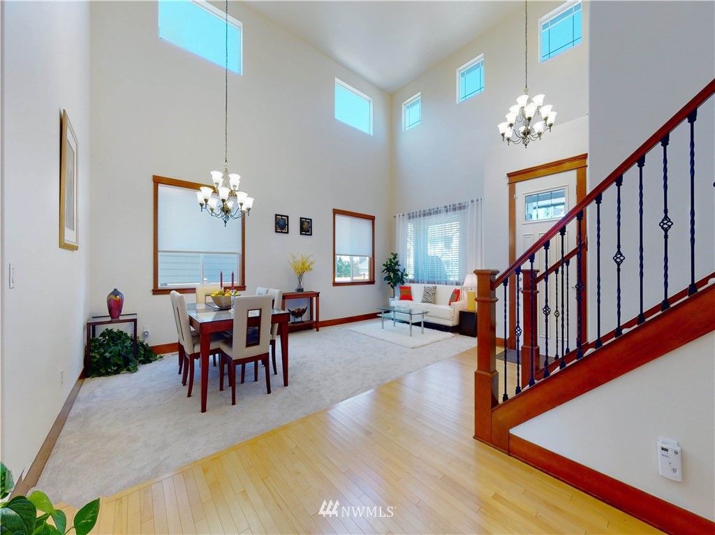 4002 216th Place Southeast Bothell, WA 98021 - Photo 8 of 28 a view of a dining room with furniture a chandelier and wooden floor