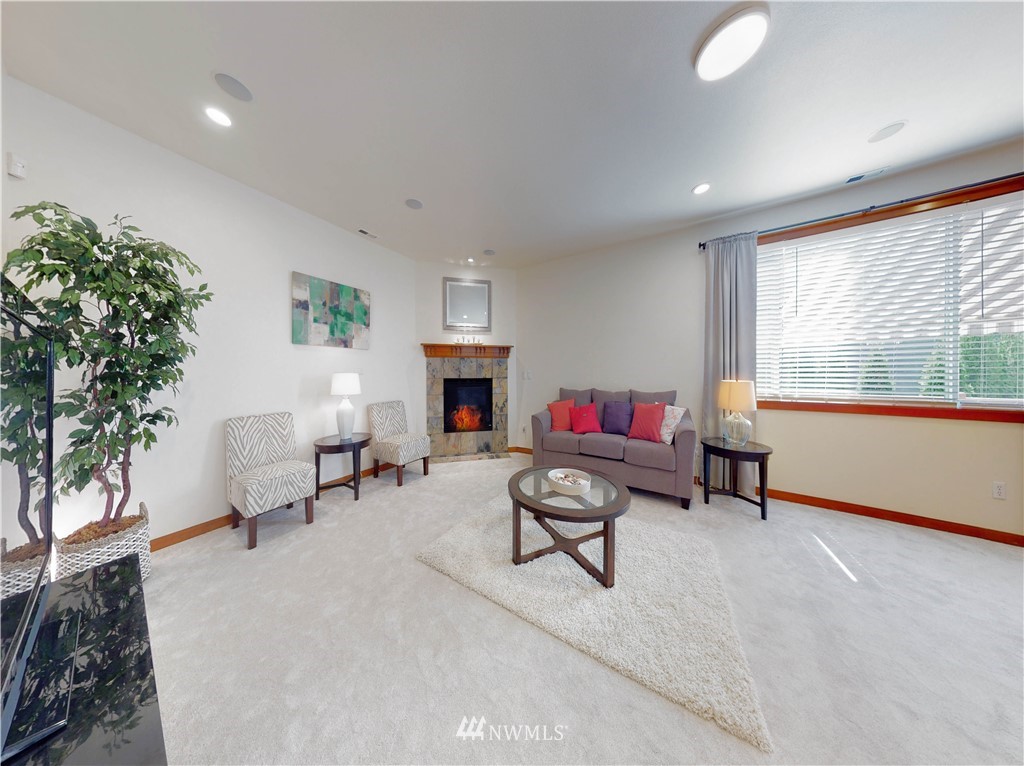 4002 216th Place Southeast Bothell, WA 98021 - Photo 10 of 28 a living room with furniture and a fireplace