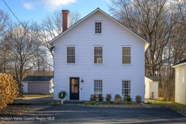 a front view of house with yard and trees