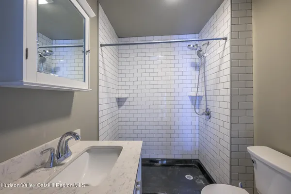 a bathroom with a sink and shower
