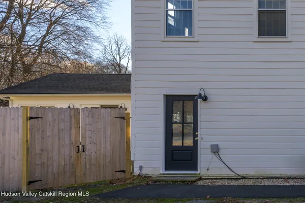 a view of brick house with wooden fence