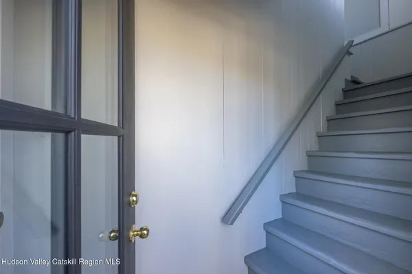 a view of staircase with lots of frames on wall