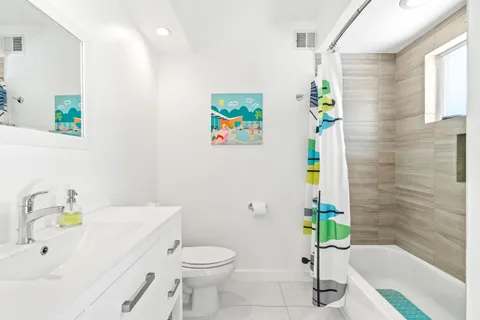 a bathroom with a sink mirror and toilet