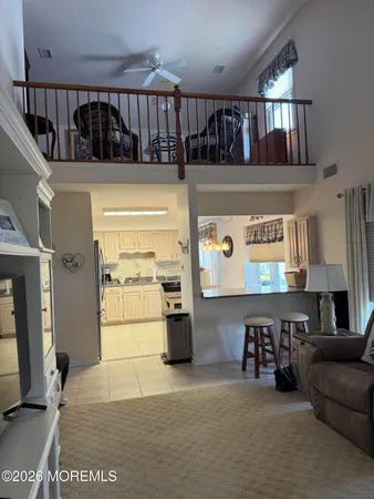 a living room with furniture a window and a flat screen tv