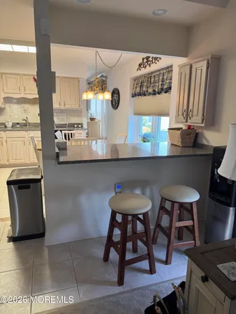 a kitchen with stainless steel appliances granite countertop a sink a stove counter space and cabinets
