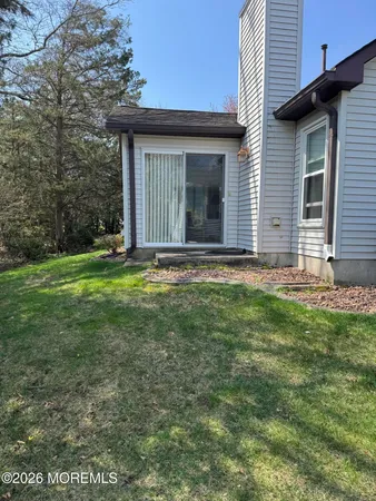a view of a house with backyard and garden