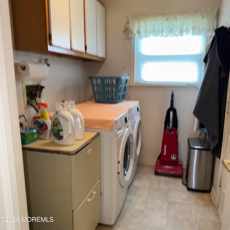 a dining room with a wooden table and chairs