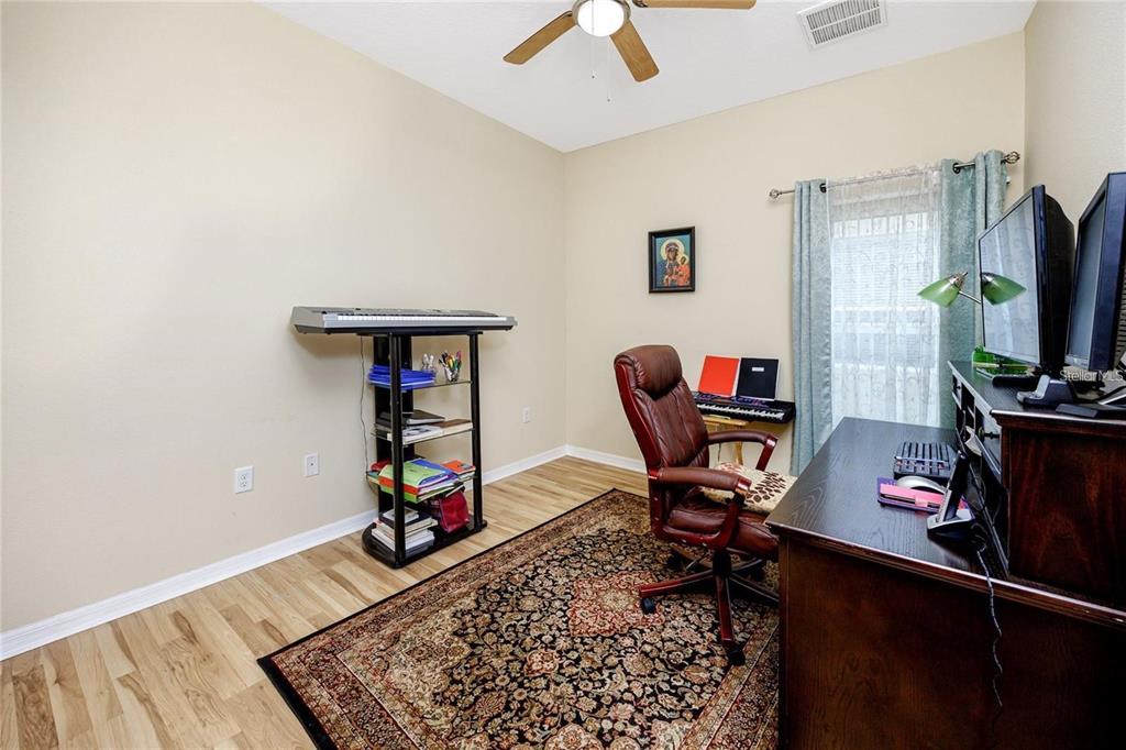 7820 Harbor Bridge Boulevard New Port Richey, FL 34654 - Photo 12 of 24 a living room with furniture and a flat screen tv
