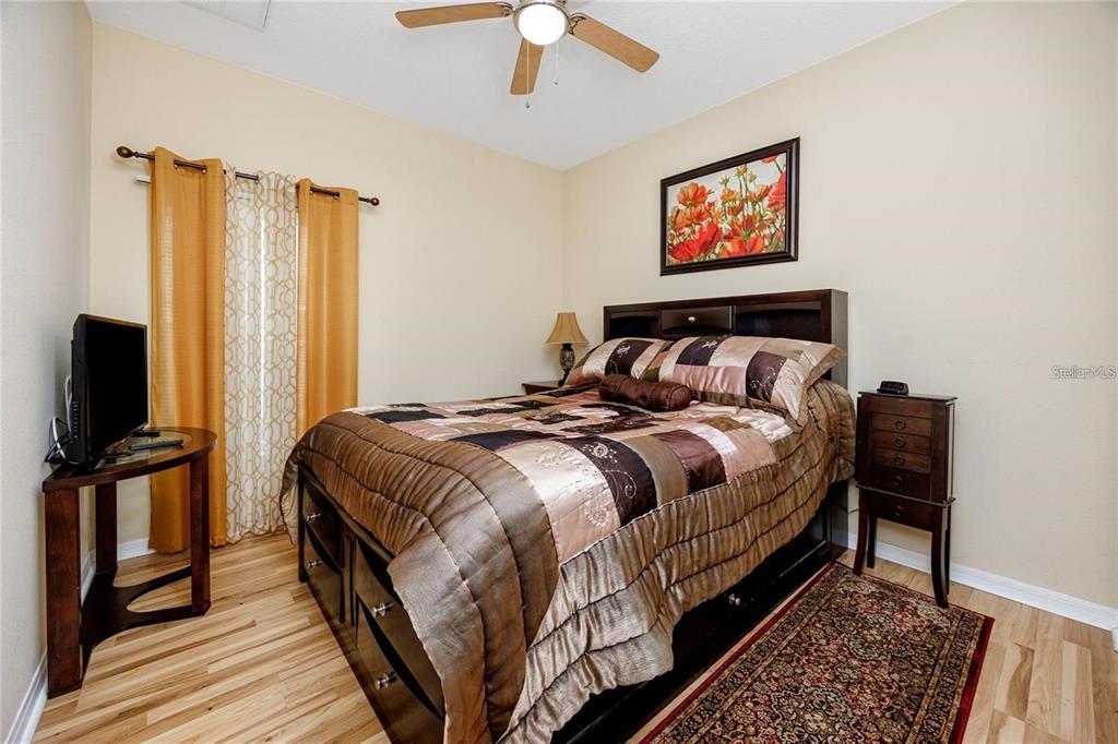 7820 Harbor Bridge Boulevard New Port Richey, FL 34654 - Photo 14 of 24 a bedroom with bed and wooden floor