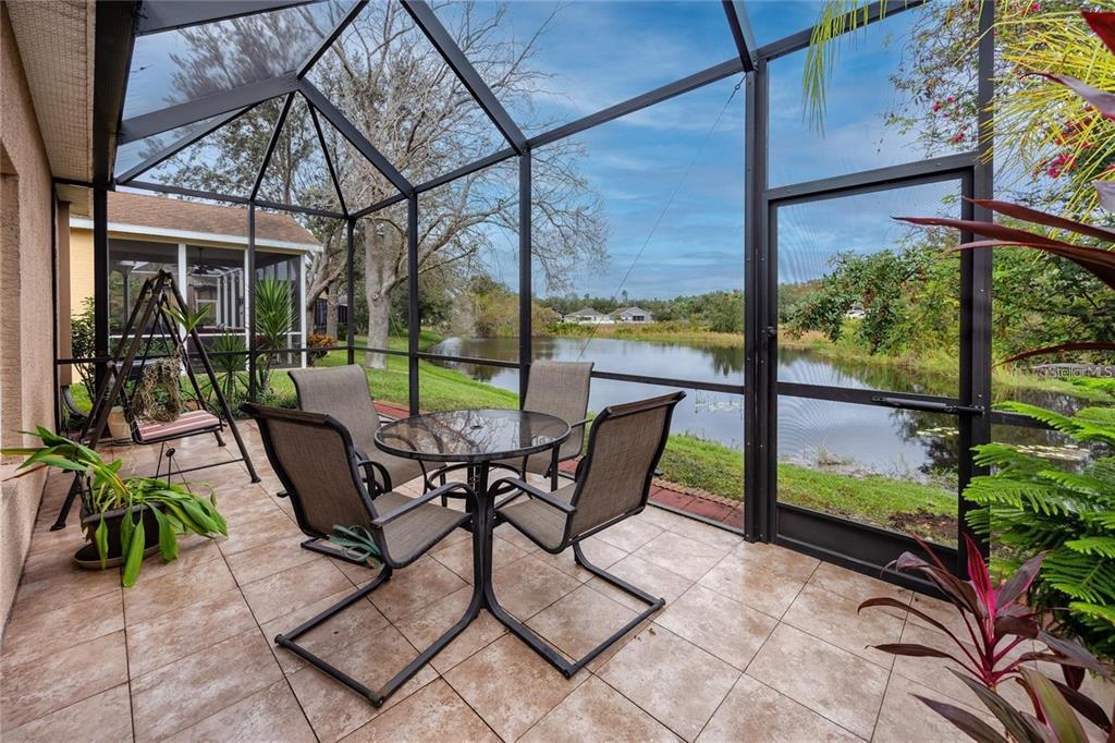 7820 Harbor Bridge Boulevard New Port Richey, FL 34654 - Photo 18 of 24 a view of chairs and table in the patio