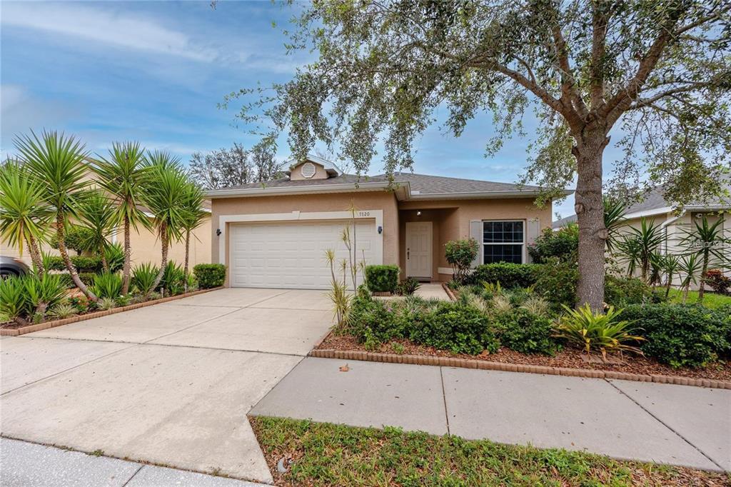 7820 Harbor Bridge Boulevard New Port Richey, FL 34654 - Photo 2 of 24 front view of a house with a small yard