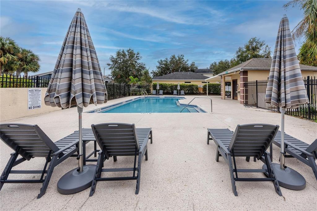 7820 Harbor Bridge Boulevard New Port Richey, FL 34654 - Photo 22 of 24 a view of a patio with a table and chairs