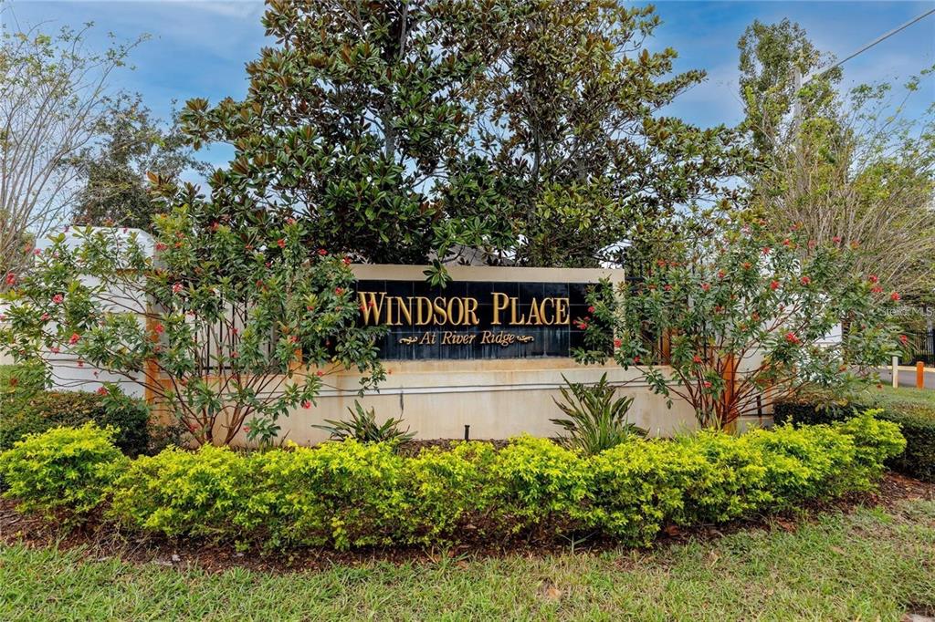 7820 Harbor Bridge Boulevard New Port Richey, FL 34654 - Photo 23 of 24 a sign that is sitting in the middle of a garden