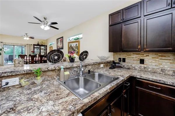 a kitchen with a sink appliances and cabinets