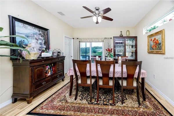 a dining room with furniture a rug and a fireplace