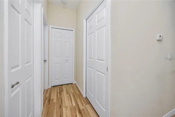 a view of a hallway with wooden floor