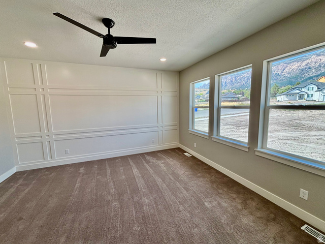 1184 West 3250 North Ogden, UT 84414 - Photo 28 of 69 Master bedroom with accent wall featuring decorative molding, dark-toned ceiling fan, recessed lighting, and three tall windows