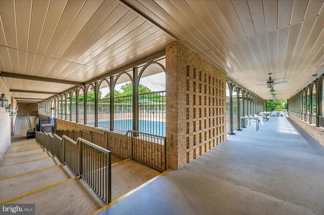 a room with pool table and windows