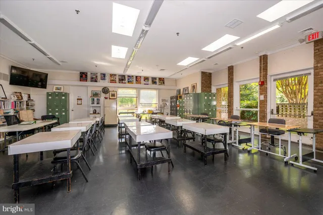 a view of a green field with trees in the background