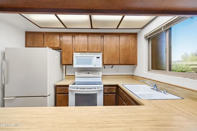 a bedroom with a bed a couch and a window