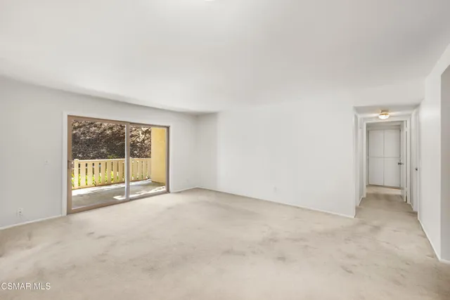 a view of a livingroom with furniture and a window