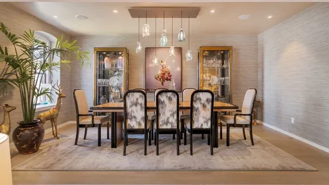 a view of a a dining room with furniture wooden floor and a rug
