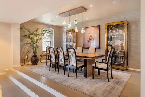 a dining room with furniture and window