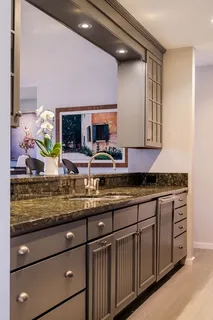 a kitchen with stainless steel appliances granite countertop a sink and a granite counter tops