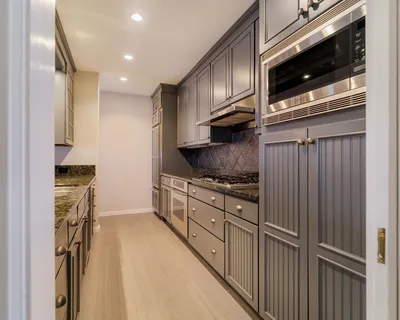 a kitchen with stainless steel appliances granite countertop a refrigerator and a stove top oven