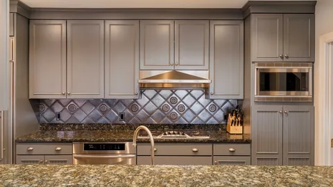 a kitchen with granite countertop white cabinets and stainless steel appliances