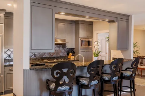 a kitchen with a table and chairs