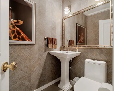 a bathroom with a sink and mirror with toilet