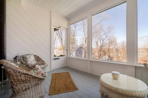a living room with couches and a dining table with garden view
