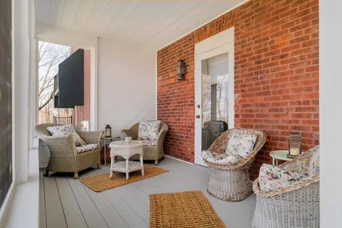 a bedroom with a bed a mirror and lamp