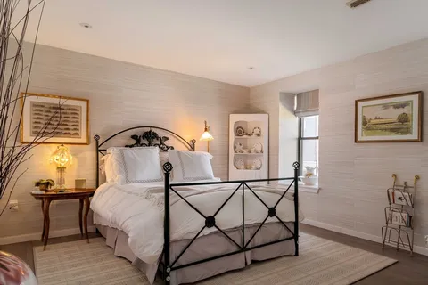 a bedroom with a bed and window