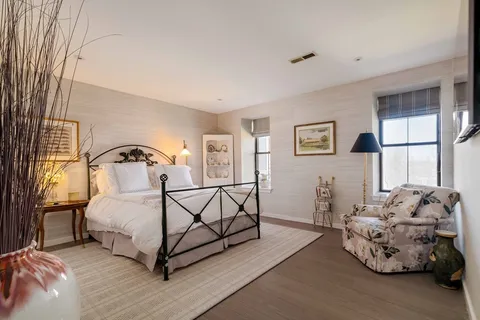 a bathroom with a double vanity sink toilet mirror and shower