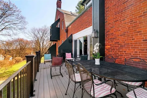 a view of a chair and tables in the back yard of the house