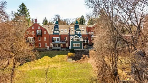 an aerial view of a house with yard