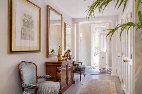 a living room with furniture and a painting on the wall