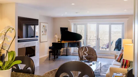 a living room with furniture fireplace and flat screen tv