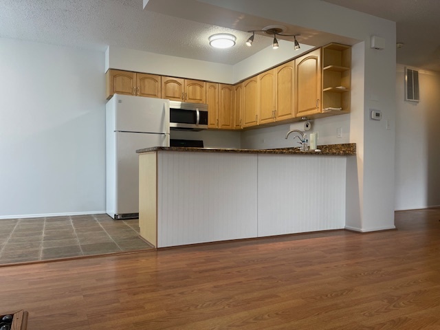 1302 Inverrary Lane, Unit 1302 Deerfield, IL 60015 - Photo 16 of 20 a kitchen with stainless steel appliances granite countertop a refrigerator a stove top oven and a sink