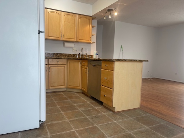 1302 Inverrary Lane, Unit 1302 Deerfield, IL 60015 - Photo 17 of 20 a view of kitchen with granite countertop cabinets and utility room view