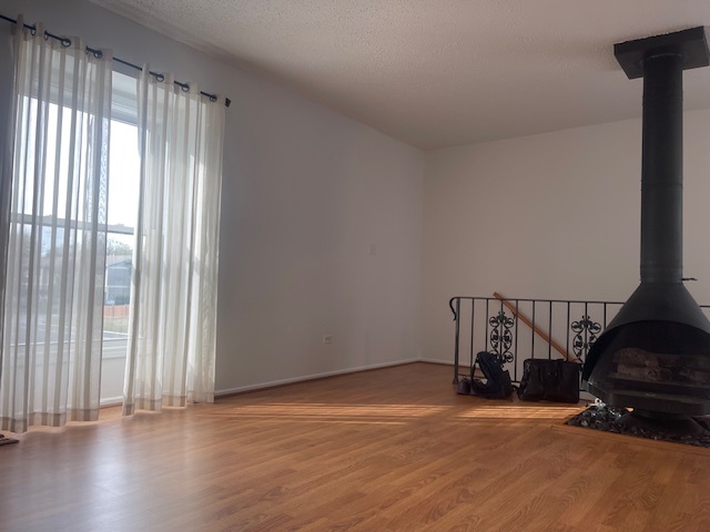 1302 Inverrary Lane, Unit 1302 Deerfield, IL 60015 - Photo 18 of 20 a view of an empty room with wooden floor and a window