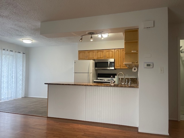 1302 Inverrary Lane, Unit 1302 Deerfield, IL 60015 - Photo 20 of 20 a kitchen with stainless steel appliances a refrigerator and a stove top oven