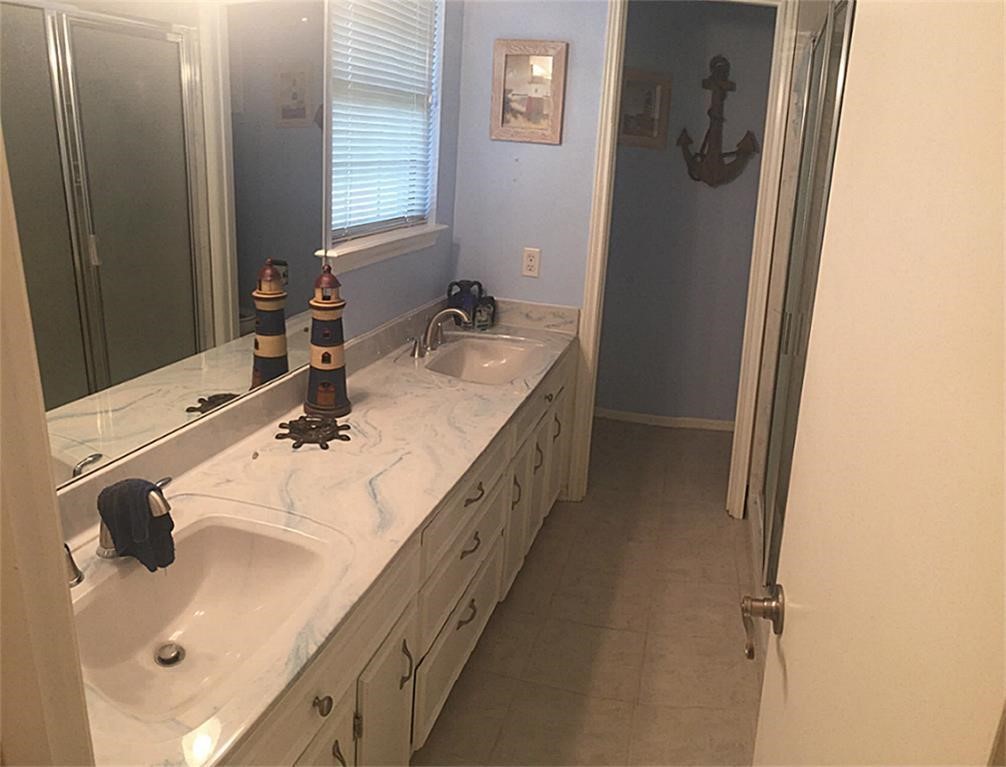 1645 9th Street Hempstead, TX 77445 - Photo 12 of 18 a bathroom with a double vanity sink a mirror and
