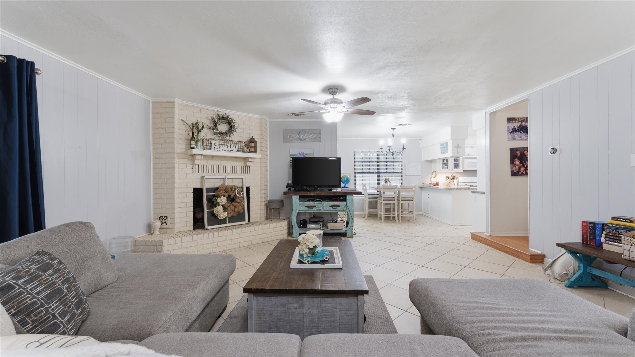 1645 9th Street Hempstead, TX 77445 - Photo 6 of 18 a living room with furniture a fireplace and a flat screen tv