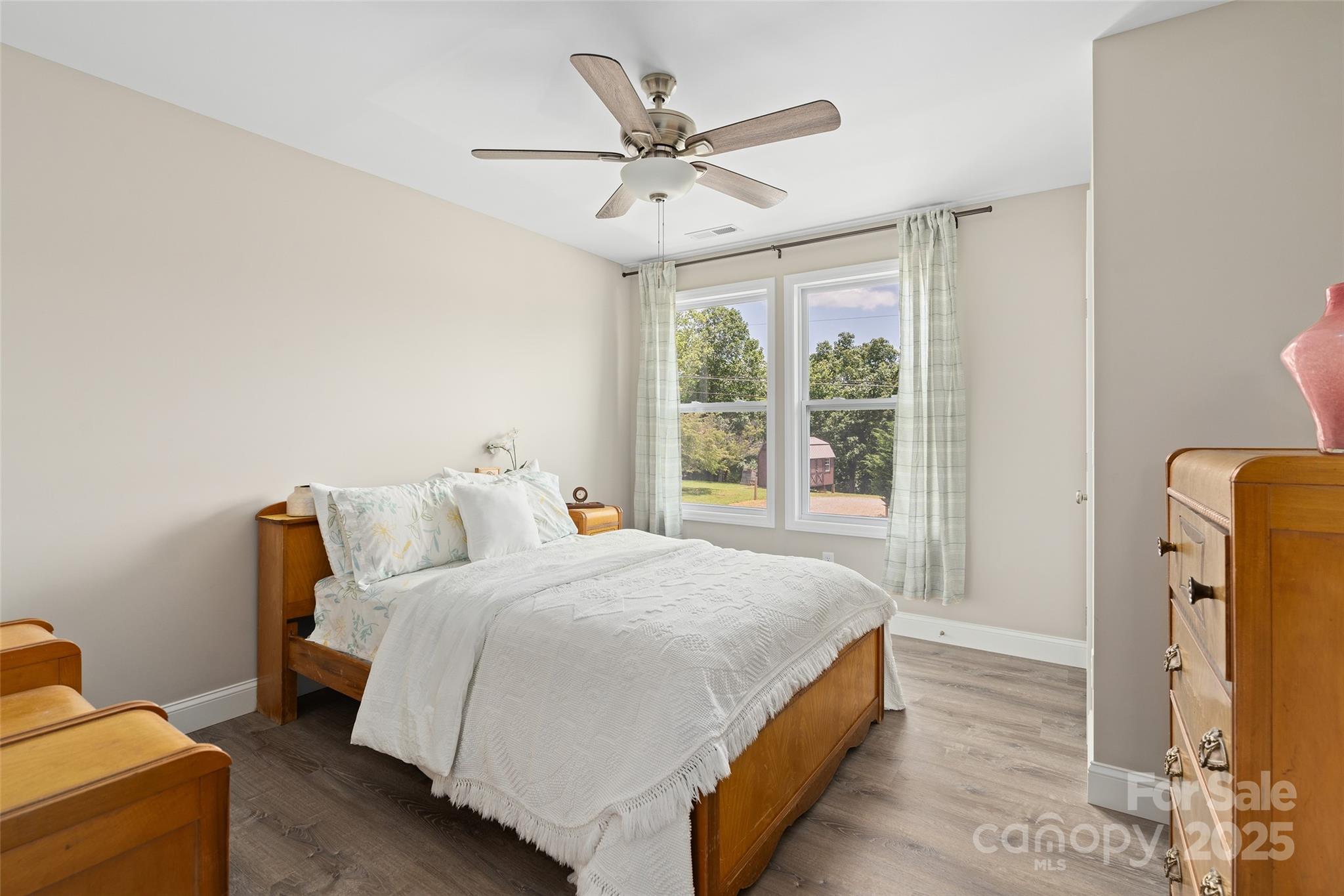 913 North Canton Road Canton, NC 28716 - Photo 20 of 25 a bed room with a bed and a ceiling fan