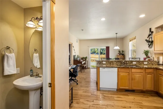 a kitchen with sink refrigerator and cabinets
