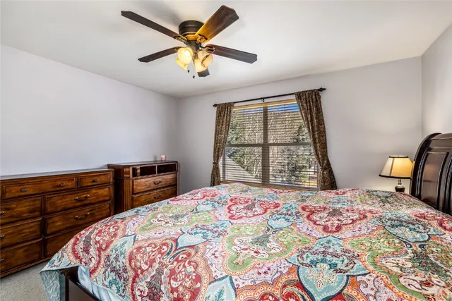 a bedroom with a bed and a large window